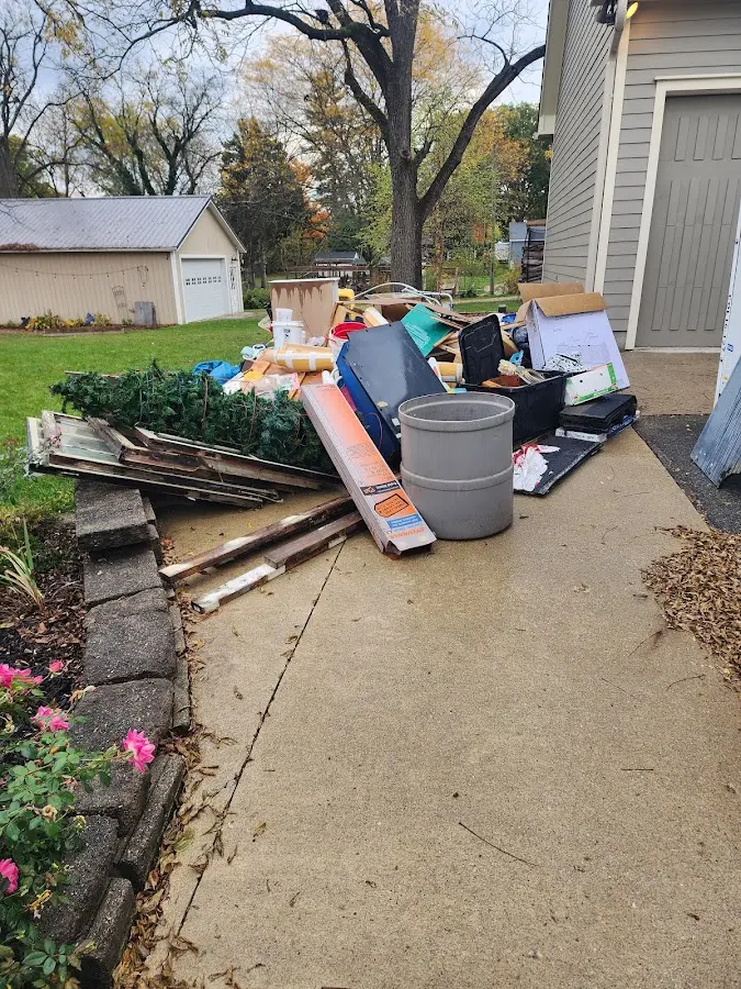 Dumpster being loaded with debris for 3 Yard Dumpster Rental in Enfield